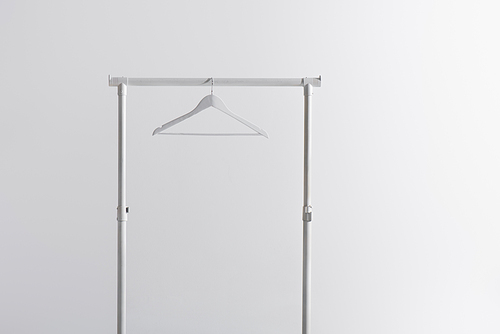 white hanger on garment rack isolated on grey