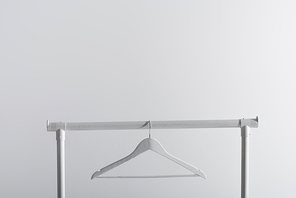 single white hanger on garment rack isolated on grey