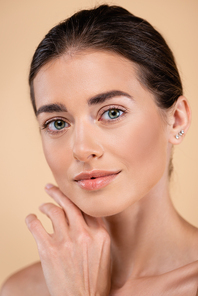 close up portrait of woman touching face while  isolated on beige, beauty concept