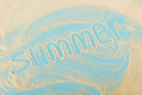 top view of summer lettering on sand and blue surface