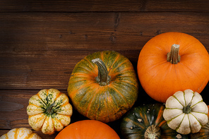 many orange pumpkins on dark wooden background,  concept, top view with copy space