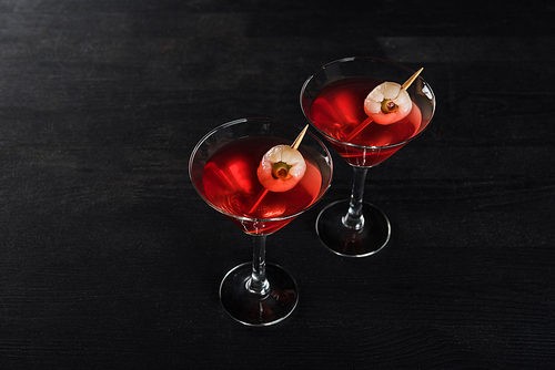 red decorated Halloween cocktails on black background