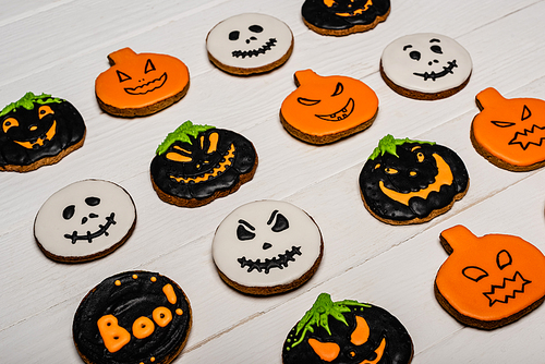 high angle view of homemade and tasty halloween cookies on white surface