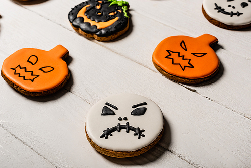 close up of sweet and spooky gingerbread cookies on white surface