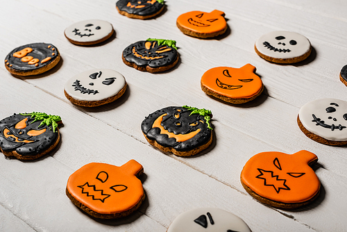 sweet and spooky pumpkin shape halloween cookies on white surface