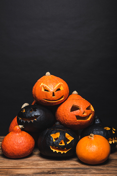stack of creepy halloween pumpkins on black