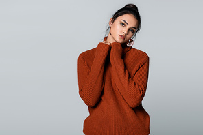 young woman in warm sweater  isolated on grey