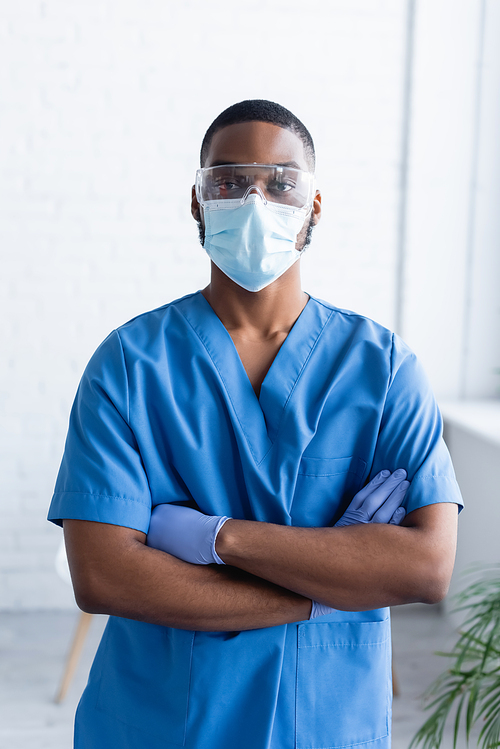 african american man in uniform and medical mask standing with crossed arms, vaccination concept