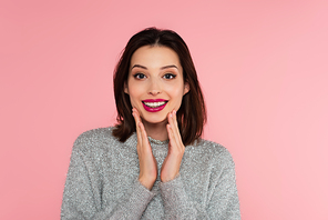 Pretty brunette woman in sweater  isolated on pink
