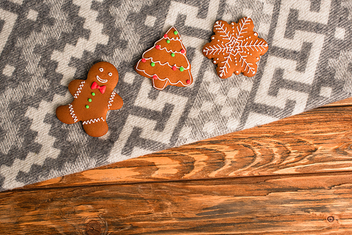 top view of gingerbread cookies on grey blanket with ornament