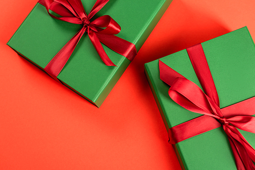 top view of green wrapped presents on red background