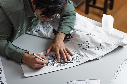 creative fashion designer creating traditional drawing on kimono