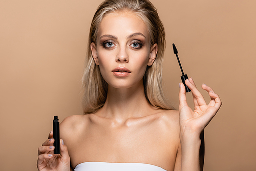 sensual young woman with black mascara  isolated on beige