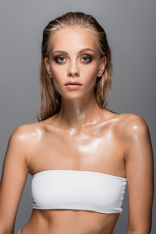 wet woman in white top  isolated on grey