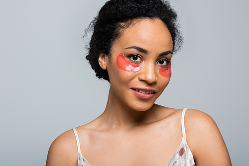 Pretty african american woman with eye patches  isolated on grey