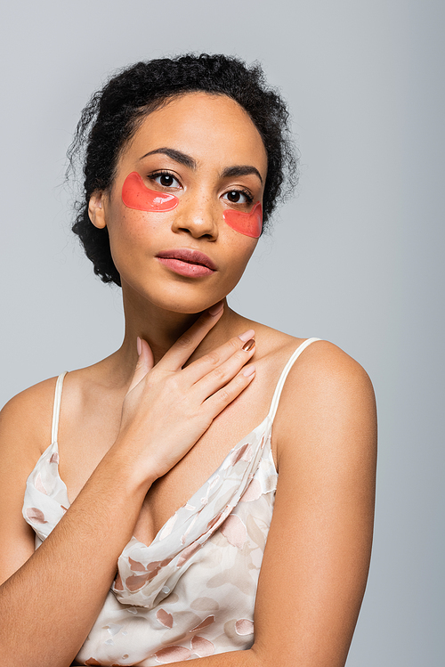 Pretty african american woman in eye patches  isolated on grey