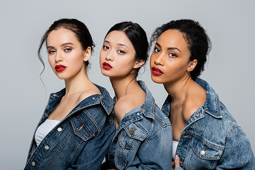 Interracial young women with red lips  isolated on grey