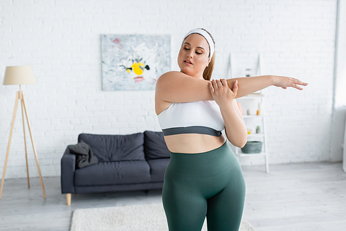 Woman with overweight exercising in living room