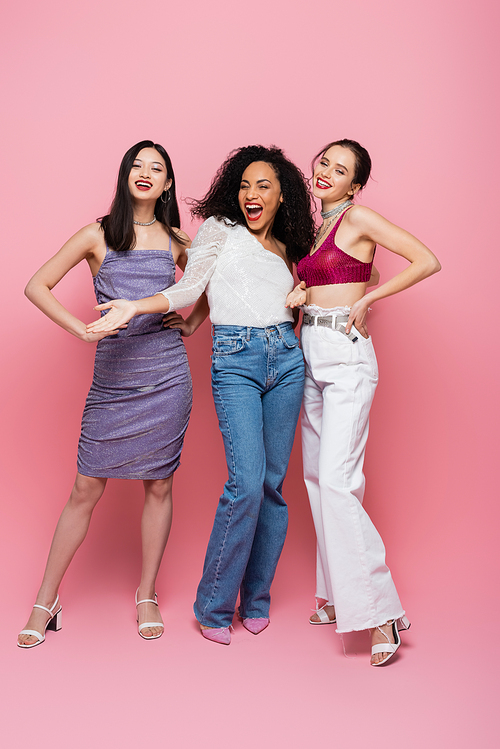 Fashionable multiethnic women  on pink background