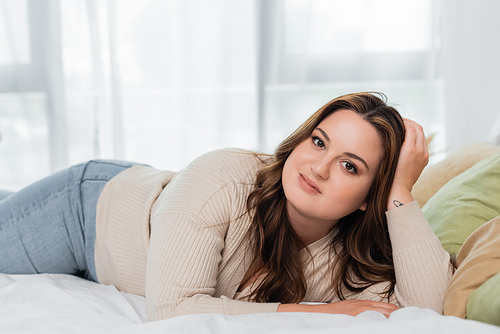 Young body positive woman  on bed