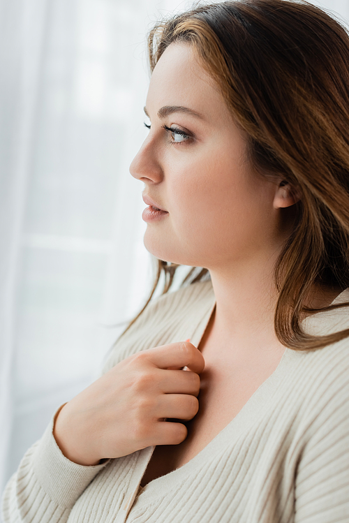 Side view of young woman with overweight looking away at home