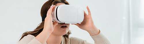 Young body positive woman using vr headset at home, banner