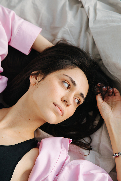 top view of young armenian woman dreaming in bedroom