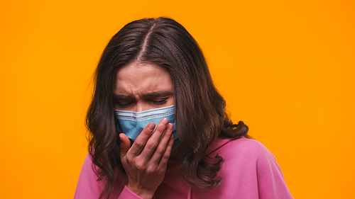 sick woman in medical mask coughing isolated on yellow