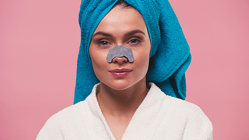 woman with blue towel on head and cleansing nose patch  isolated on pink