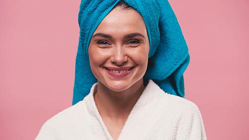 cheerful woman with clean face and terry towel on head  isolated on pink