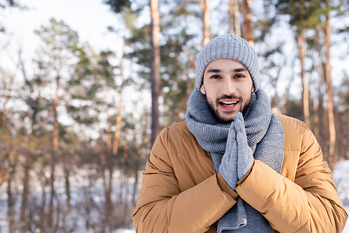 Happy man in warm clothes standing outdoors