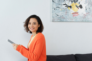 happy young woman using digital tablet at home