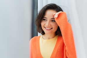 portrait of joyful young woman smiling at home