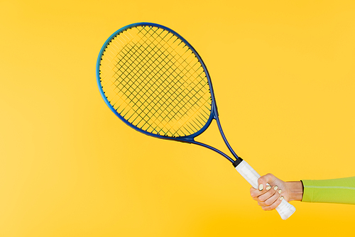 cropped view of sportswoman holding tennis racquet isolated on yellow