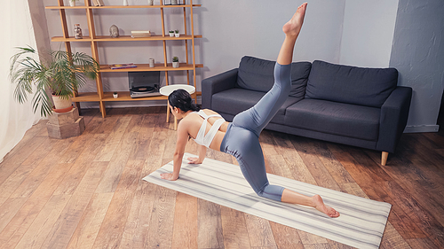 High angle view of sportswoman working on buttocks on fitness mat at home