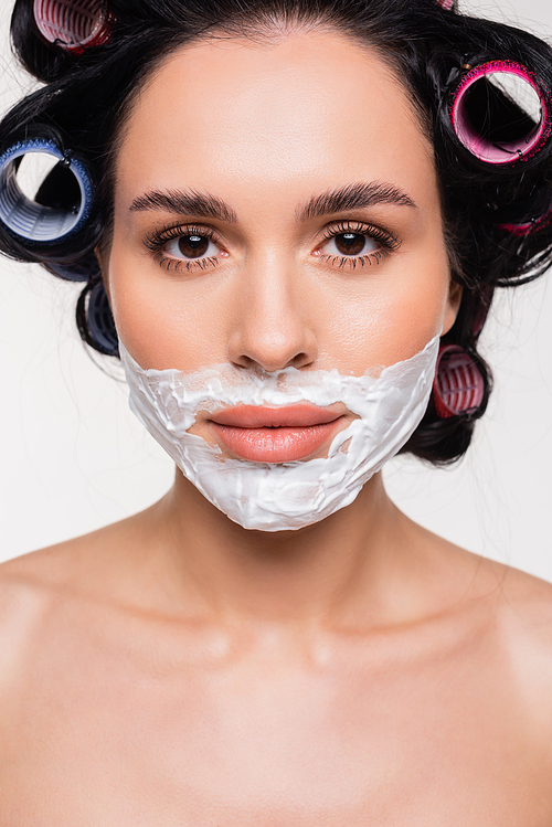 portrait of young woman with shaving cream on face isolated on white