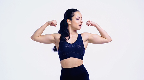 strong sportswoman showing muscles isolated on white