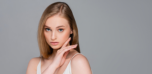 pretty young woman with makeup  isolated on gray, banner