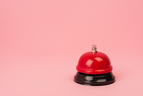 red and metallic bell isolated on pink