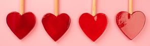 flat lay of heart-shaped lollipops isolated on pink, banner