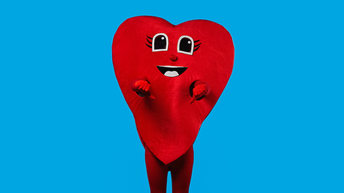 person in red heart costume showing dislike isolated on blue