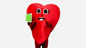 person in red heart costume holding digital tablet with green screen and showing thumb up isolated on white