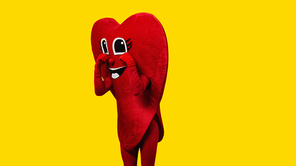 person in heart-shaped costume touching cartoon eyes while imitating crying isolated on yellow