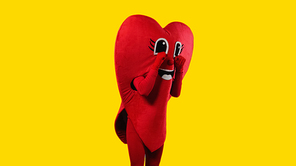 person in heart costume touching cartoon eyes while imitating crying isolated on yellow