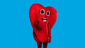 person in positive heart costume showing okay isolated on blue