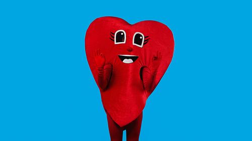 person in happy heart costume showing okay with hands isolated on blue