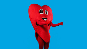 person in cheerful heart costume showing thumbs up isolated on blue