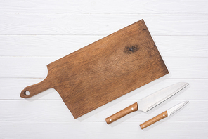 top view of cutting board and knives on white table