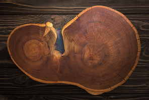 top view of wooden cutting board on brown table