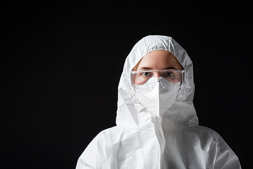 doctor in goggles, medical mask and white hazmat suit  on black, omicron variant concept